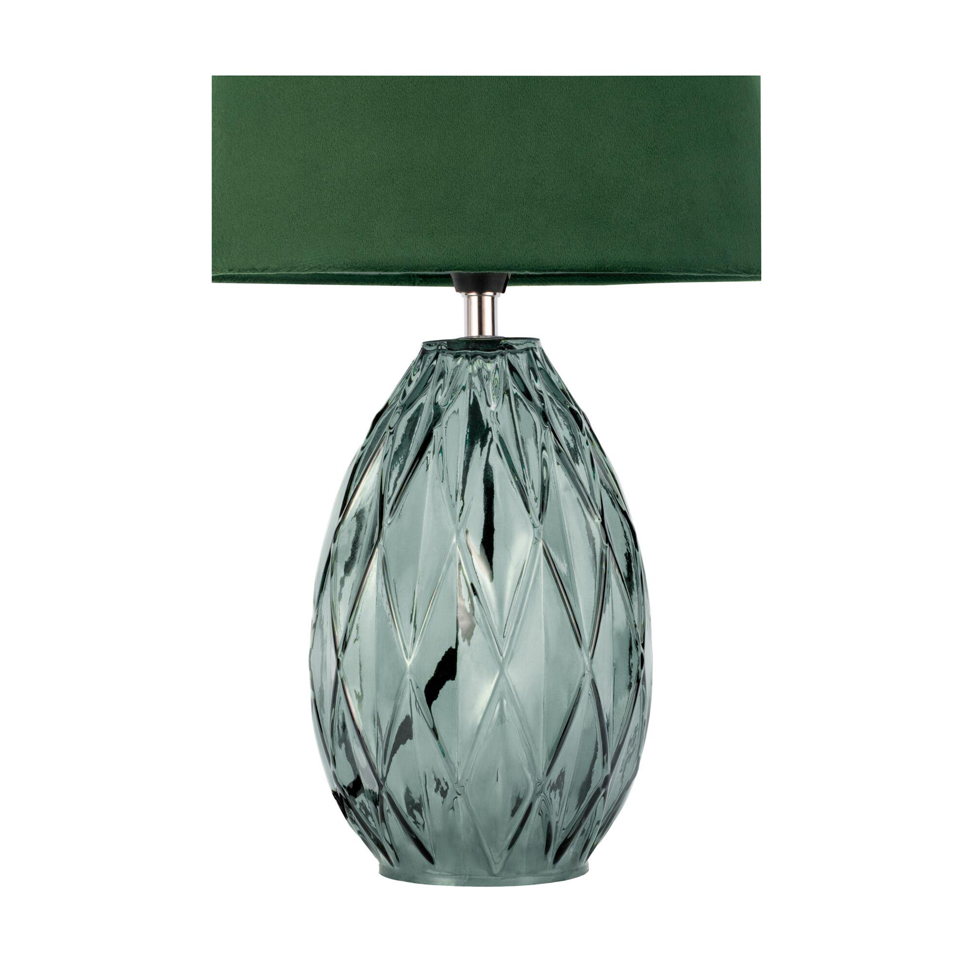 Table lamp with green fabric shade and textured emerald glass base for stylish home lighting
