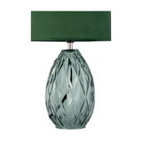 Table lamp with green fabric shade and textured emerald glass base for stylish home lighting
