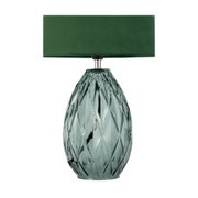 Table lamp with green fabric shade and textured emerald glass base for stylish home lighting
