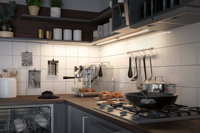 Modern kitchen with wooden countertop, stainless steel gas stove, black pan, and LED under-cabinet lighting.