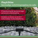 Zwart Plug & Shine besturingsapparaat op grind met groene achtergrond, IP68 bescherming voor buitenverlichting