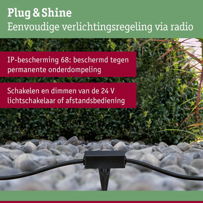 Zwart Plug & Shine besturingsapparaat op grind met groene achtergrond, IP68 bescherming voor buitenverlichting