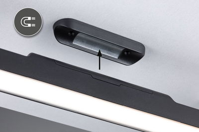Black plastic magnetic mount on grey wall with LED light bar below