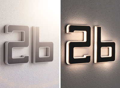 Moderne Hausnummer 2b aus schwarzem Material mit weißer LED-Beleuchtung an Wand bei Tag und Nacht