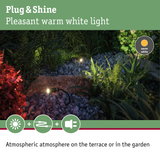 Outdoor garden lighting with warm white light on pebbles for atmospheric terrace illumination