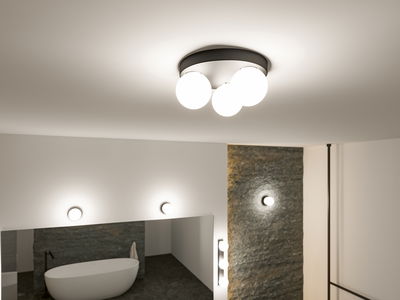 Modern ceiling light with three white glass globes and black metal ring in stylish bathroom with bathtub