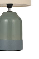 Table lamp with green ceramic base and grey bottom, cream fabric shade, decorative home lighting