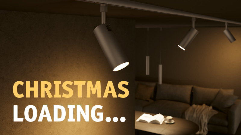 Modern black LED ceiling spotlights illuminate cozy living room with sofa and table, hinting Christmas atmosphere