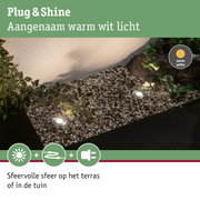 Buitenverlichting met warm wit licht op grind en planten voor terras en tuin