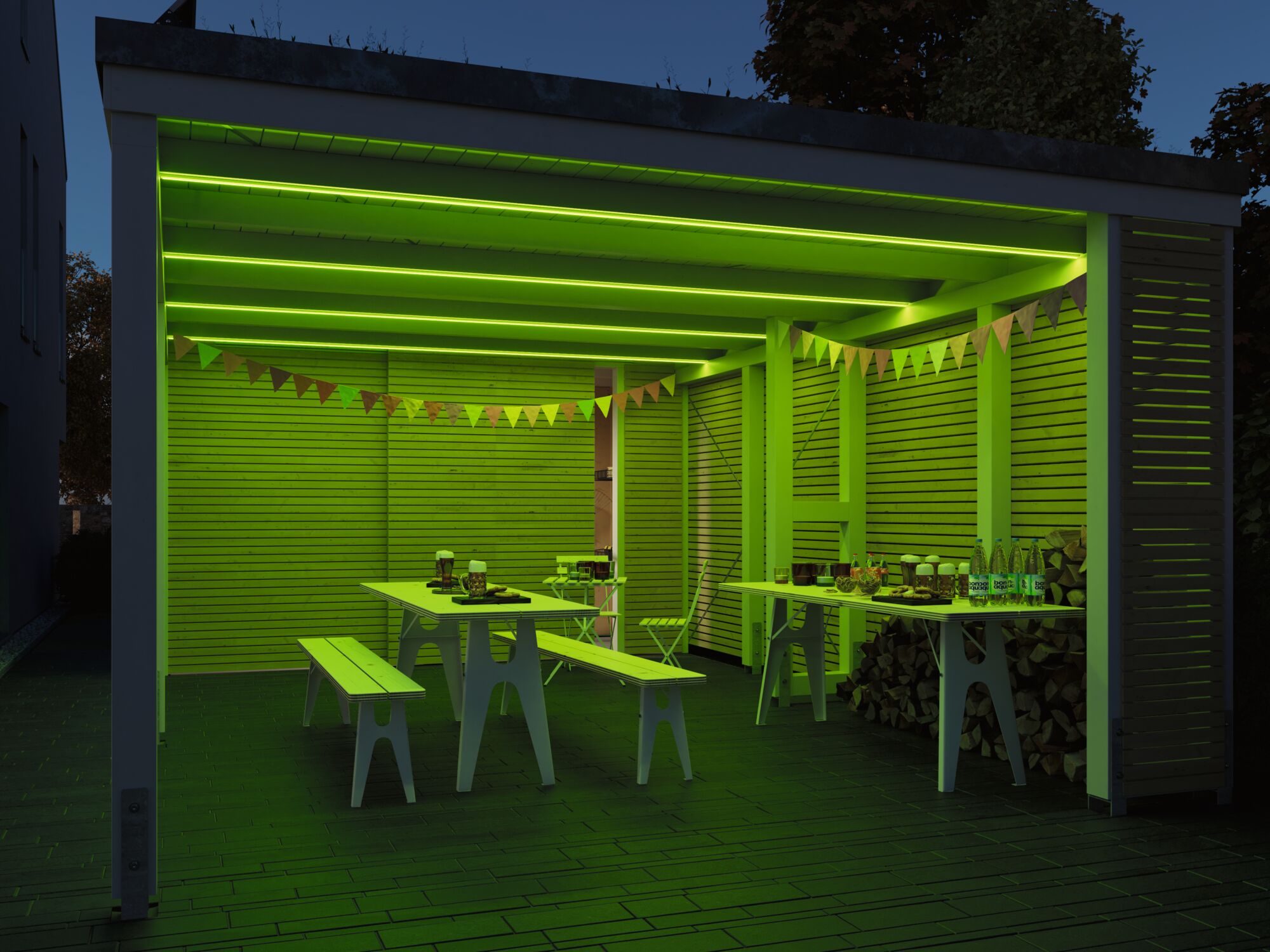 Modern outdoor space with green LED lighting, white wooden tables and benches for garden party.