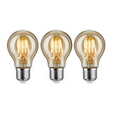 Three LED light bulbs with warm white light and transparent amber glass for energy-efficient lighting