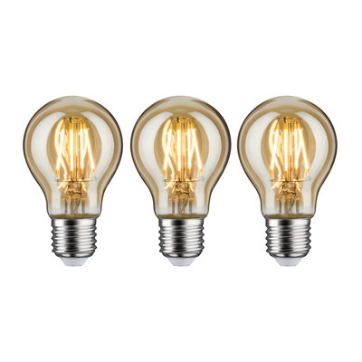 Three LED light bulbs with warm white light and transparent amber glass for energy-efficient lighting