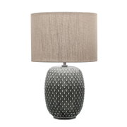 Table lamp with grey textured ceramic base and beige fabric shade for home lighting decor