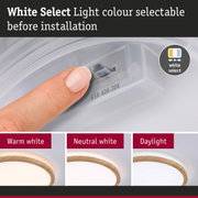Finger adjusting White Select Light with three colour temperature options before installation