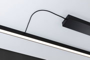 Black LED ceiling light with slim, elongated design and warm white light for modern interiors.
