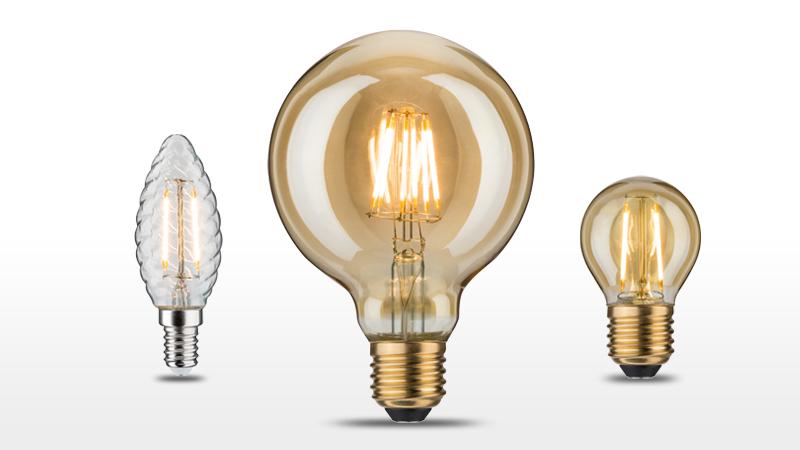 Drie decoratieve vintage amberkleurige gloeilampen met zichtbare filamenten voor sfeerverlichting.