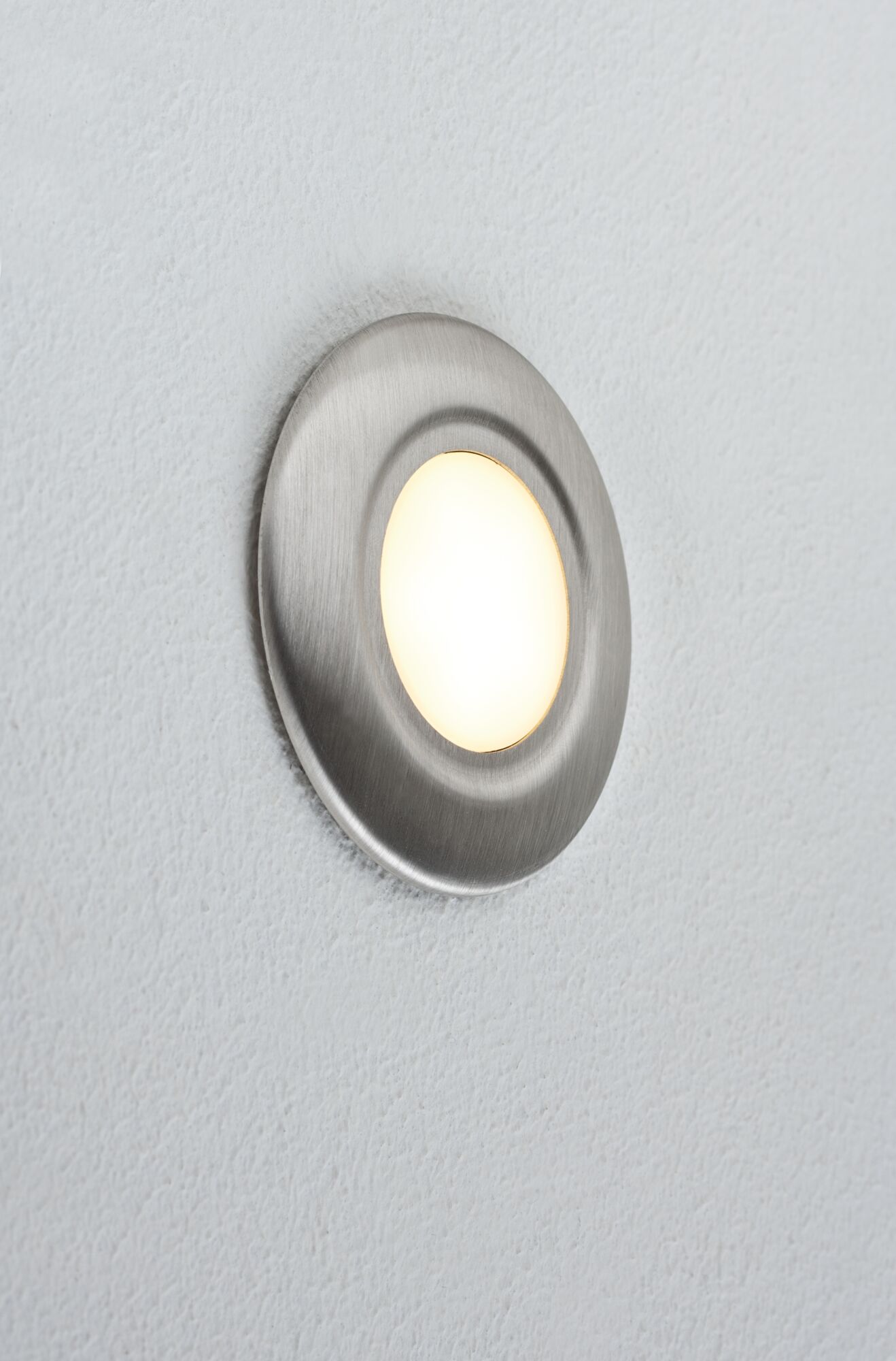 Round LED wall light in brushed stainless steel with warm white light for modern interiors