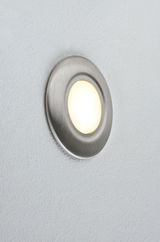Round LED wall light in brushed stainless steel with warm white light for modern interiors