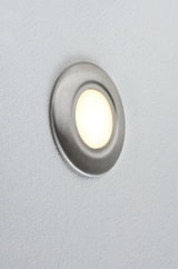 Round LED wall light in brushed stainless steel with warm white light for modern interiors