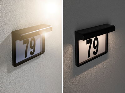 Black LED house number sign with illuminated number 79 on textured wall in day and night view