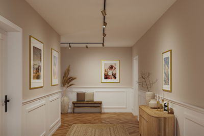 Modern hallway with brown wooden floor, white wall panels and black Paulmann LED ceiling spotlights
