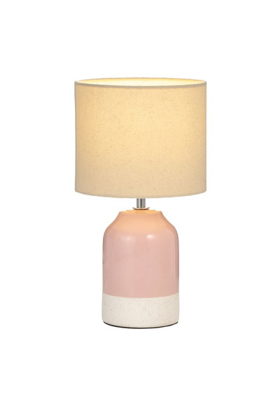 Table lamp with pink ceramic base and beige fabric shade for cozy home lighting