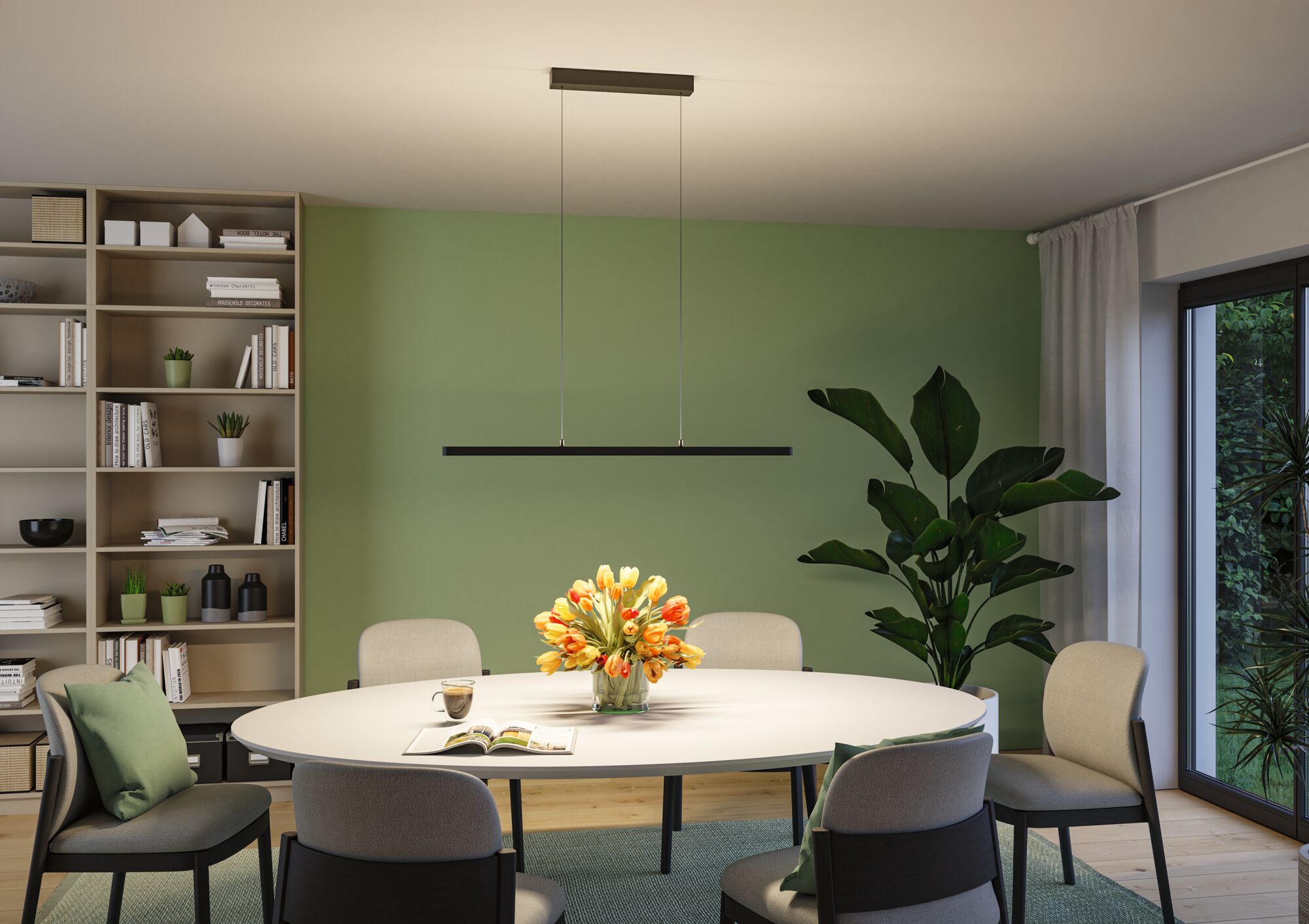 Schwarze LED-Pendelleuchte aus Metall über rundem Esstisch mit Blumenstrauß und grüner Wand