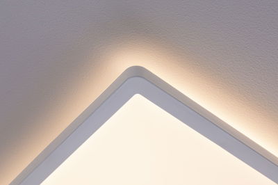 Square white LED ceiling light with indirect warm white illumination for modern interiors