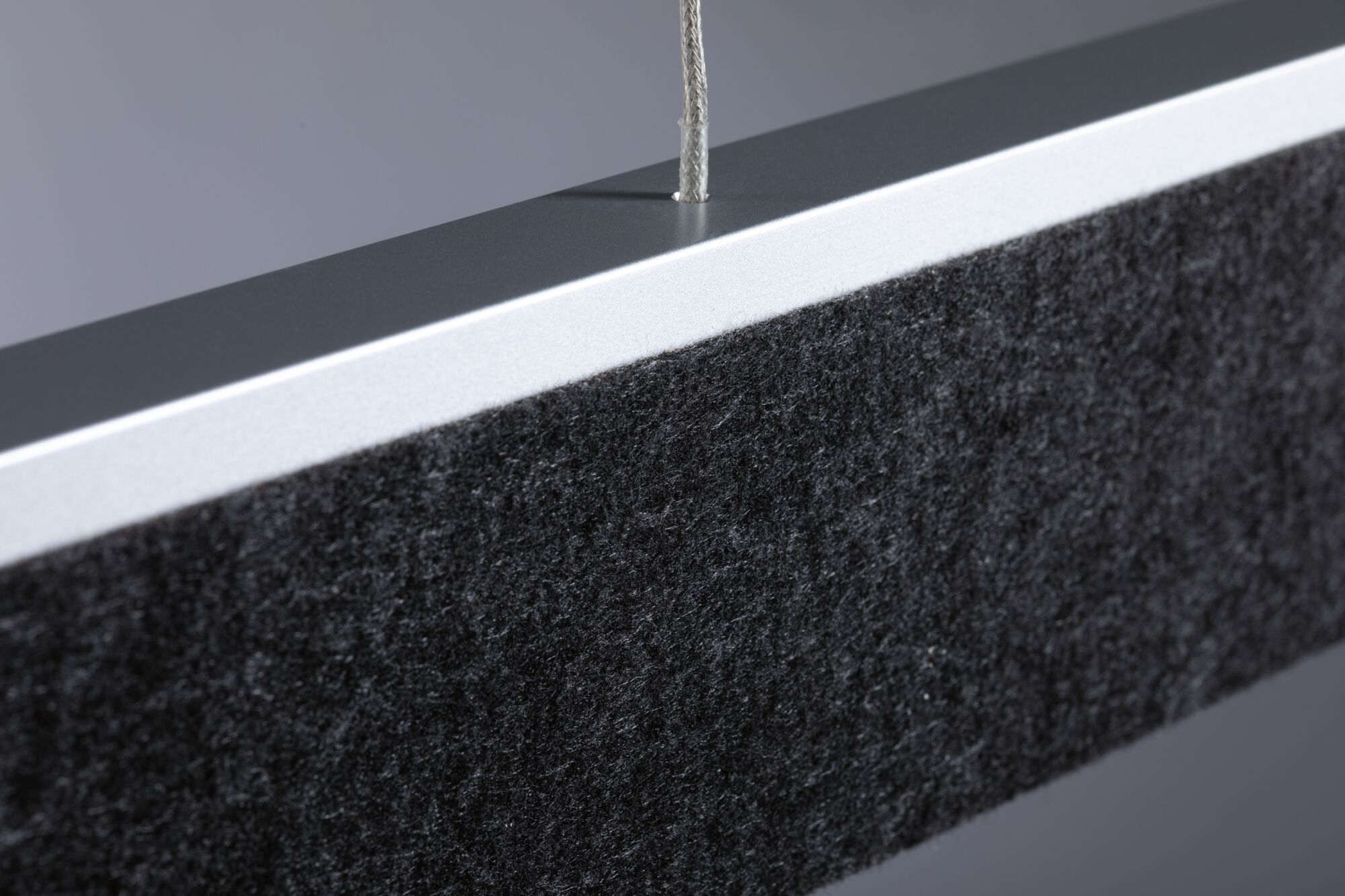 Modern rectangular black acoustic panel with aluminium frame and suspension cable for sound absorption