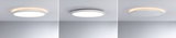 Three white round LED ceiling lights with warm white light and modern design on gray ceiling