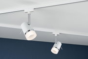 Modern white metal LED spotlight with chrome accents on track system for indoor lighting