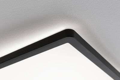 Black aluminum ceiling light with white diffuser and indirect LED lighting for modern interior design
