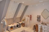Modern dressing room with white wooden cabinet, clothes rack and Paulmann white LED cable lighting system.