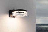 Modern black LED wall light with round acrylic glass and warm white light for outdoor use