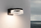 Modern black LED wall light with round acrylic glass and warm white light for outdoor use