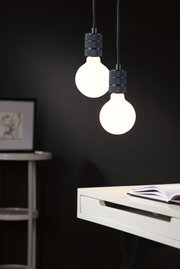 Two hanging LED bulbs with matte black fittings against dark background in modern interior lighting