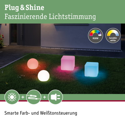 Bunte Plug & Shine LED-Leuchten in Kugel- und Würfelform auf Rasen mit RGBW und Weißtonsteuerung