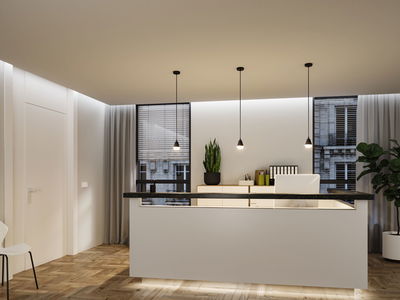 Modernes Büro mit drei schwarzen Paulmann LED Pendelleuchten und weißem Empfangstresen aus Holz.