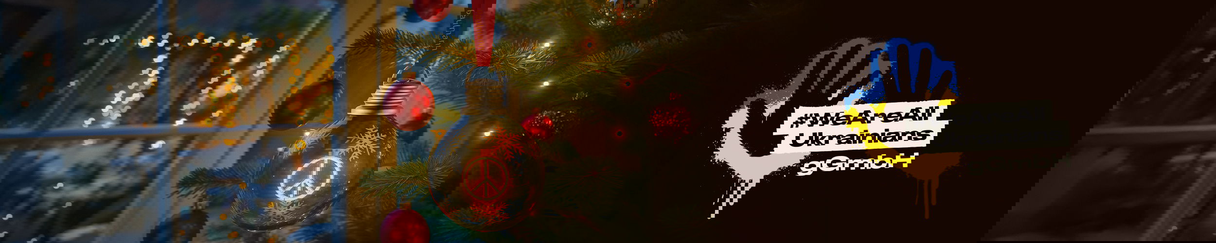 Christmas tree decorated with red baubles and warm white LED lights creating festive atmosphere