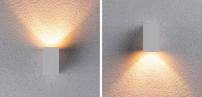 Modern white metal wall light with warm white LED light shining up and down.