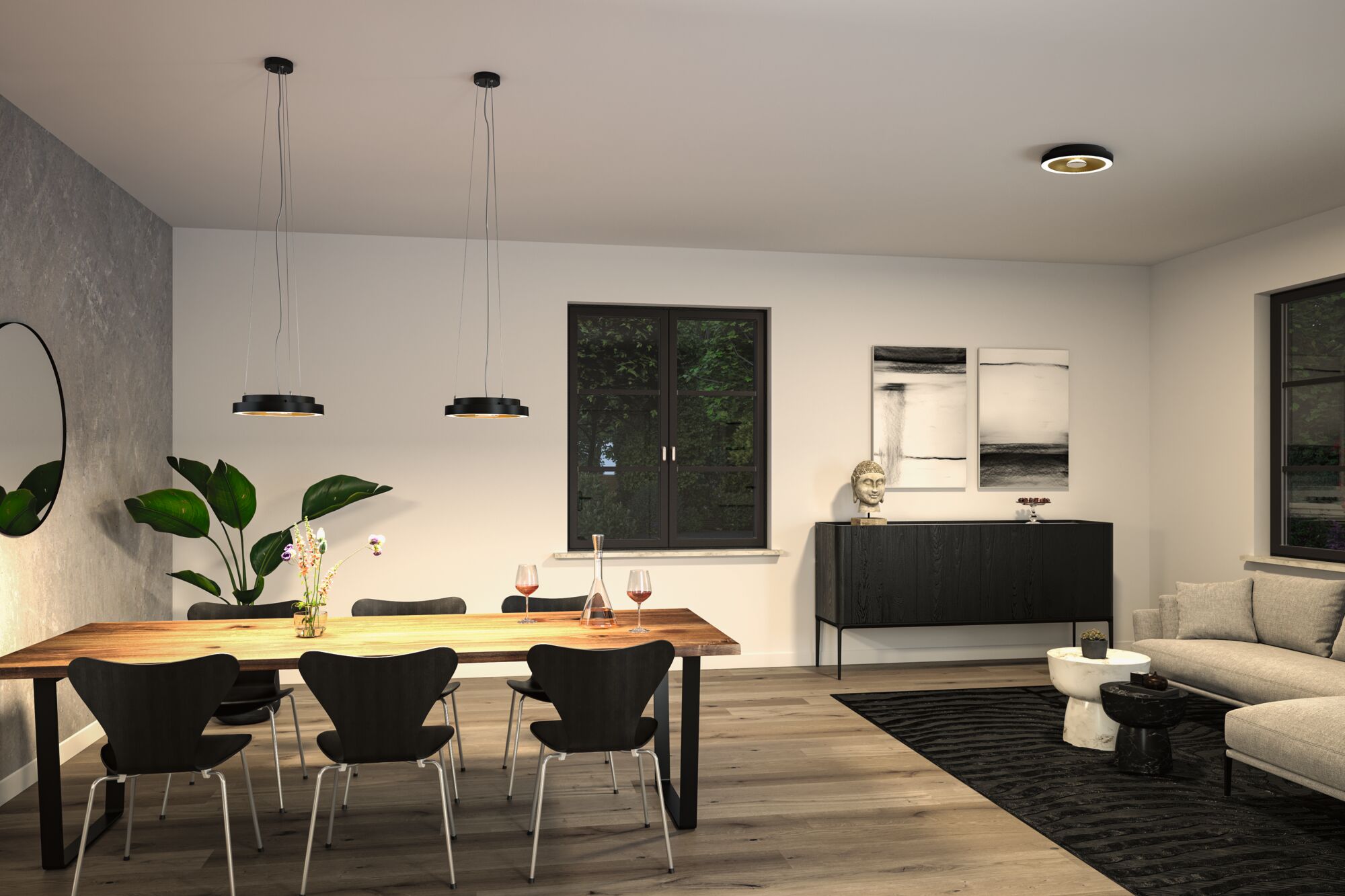 Modern dining room with black metal pendant and ceiling lights, wooden table and glassware