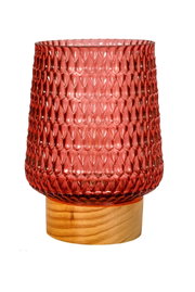 Red textured glass candle holder on light wooden base for home decoration and lighting