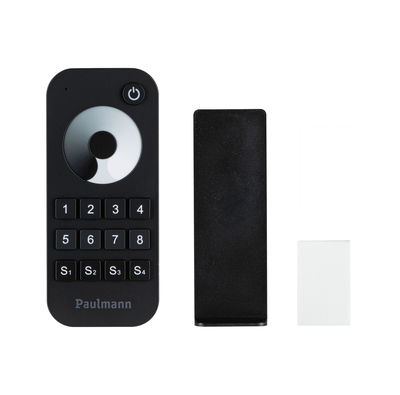 Black remote control with buttons and dial for light control, including mount and adhesive pad