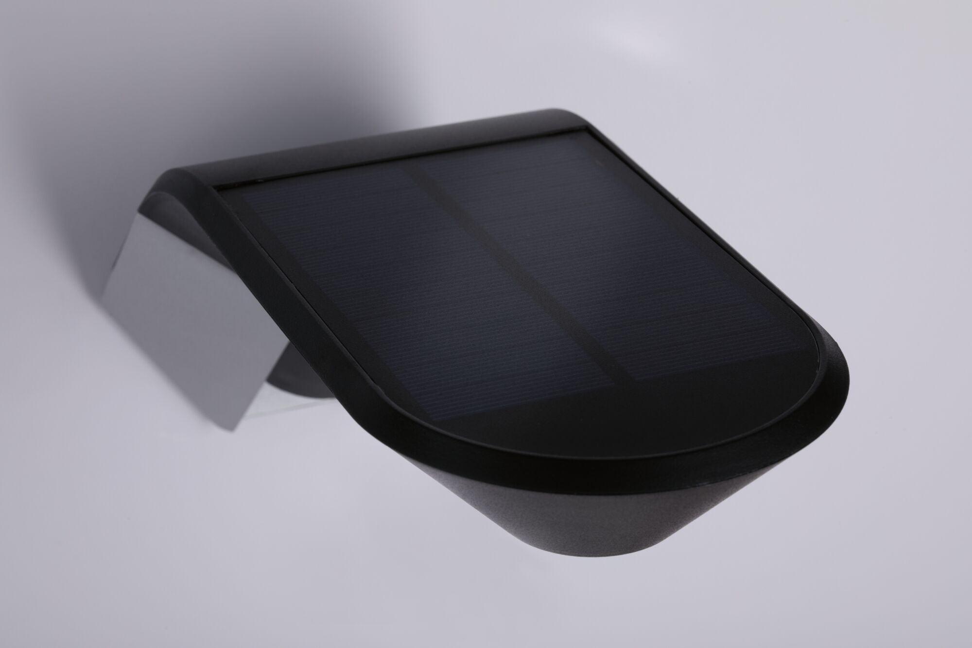 Black solar light with plastic housing and wall mount for energy-saving outdoor lighting