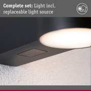 Close-up of black lamp with built-in replaceable light source for indoor lighting