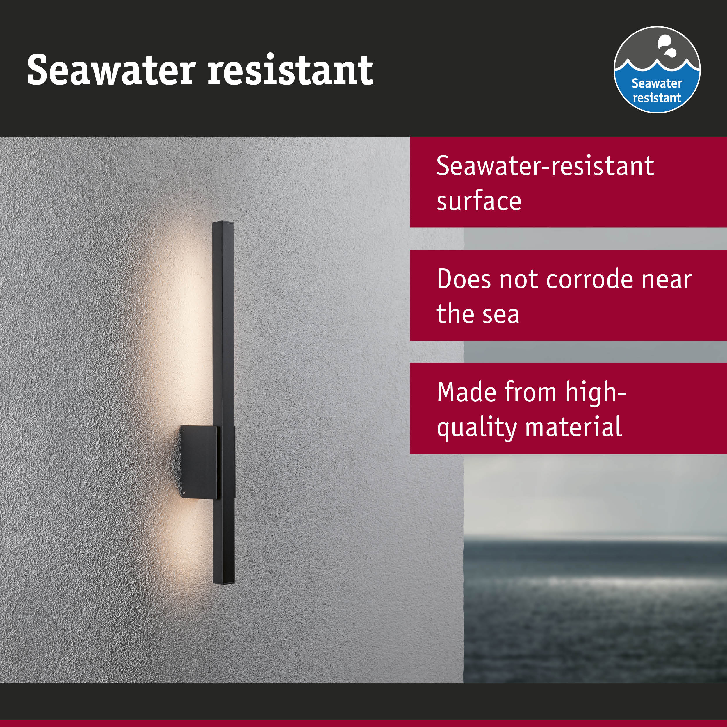 Black wall light with seawater-resistant surface mounted on grey wall overlooking the sea