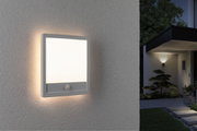 White square LED outdoor wall light with motion sensor mounted on house wall for garden lighting