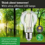 Clear LED bulb with warm white light and ultra-efficient energy use against green forest background