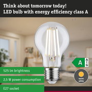 Clear LED bulb with warm white light and ultra-efficient energy use against green forest background