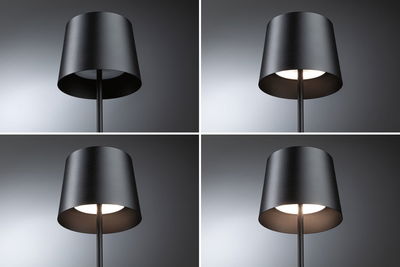 Vier Ansichten einer schwarzen Metall-Stehlampe mit zylindrischem Schirm und warmweißem Licht für Wohnräume